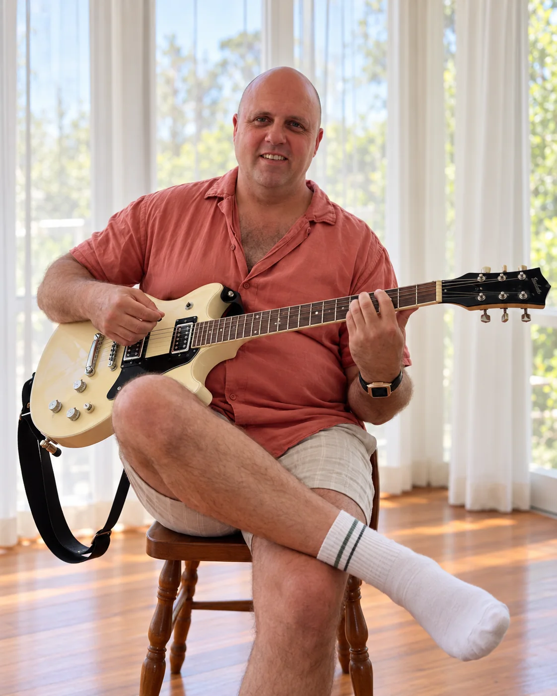 AI-assisted image of Alex seated at home with his cream electric guitar, based on his own photograph
